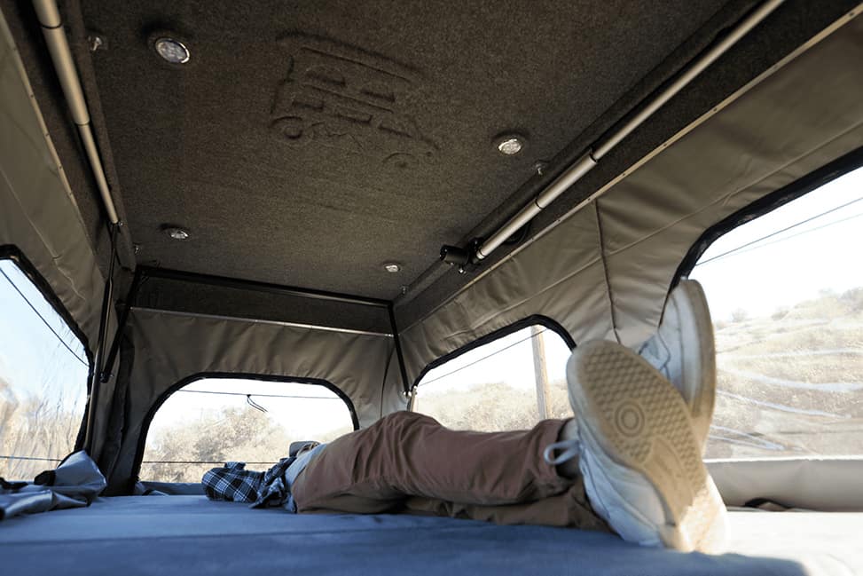 Escape Campervans Del Mar-5 Berth-man-on-bed